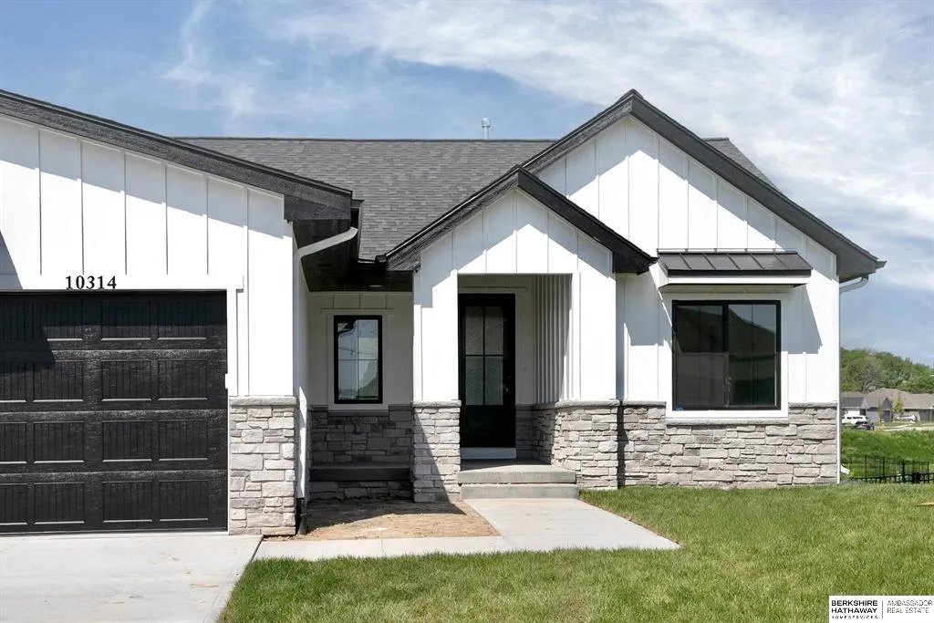 Modern farmhouse-style home with stone accents