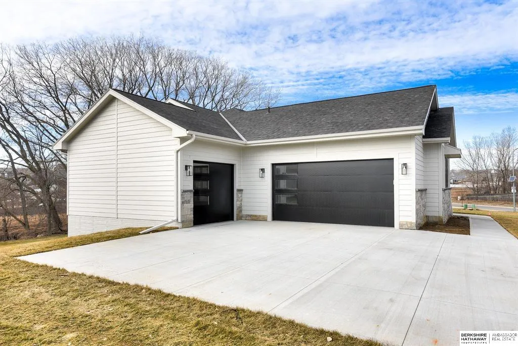 Danielson home with a wide concrete driveway and two-car garage