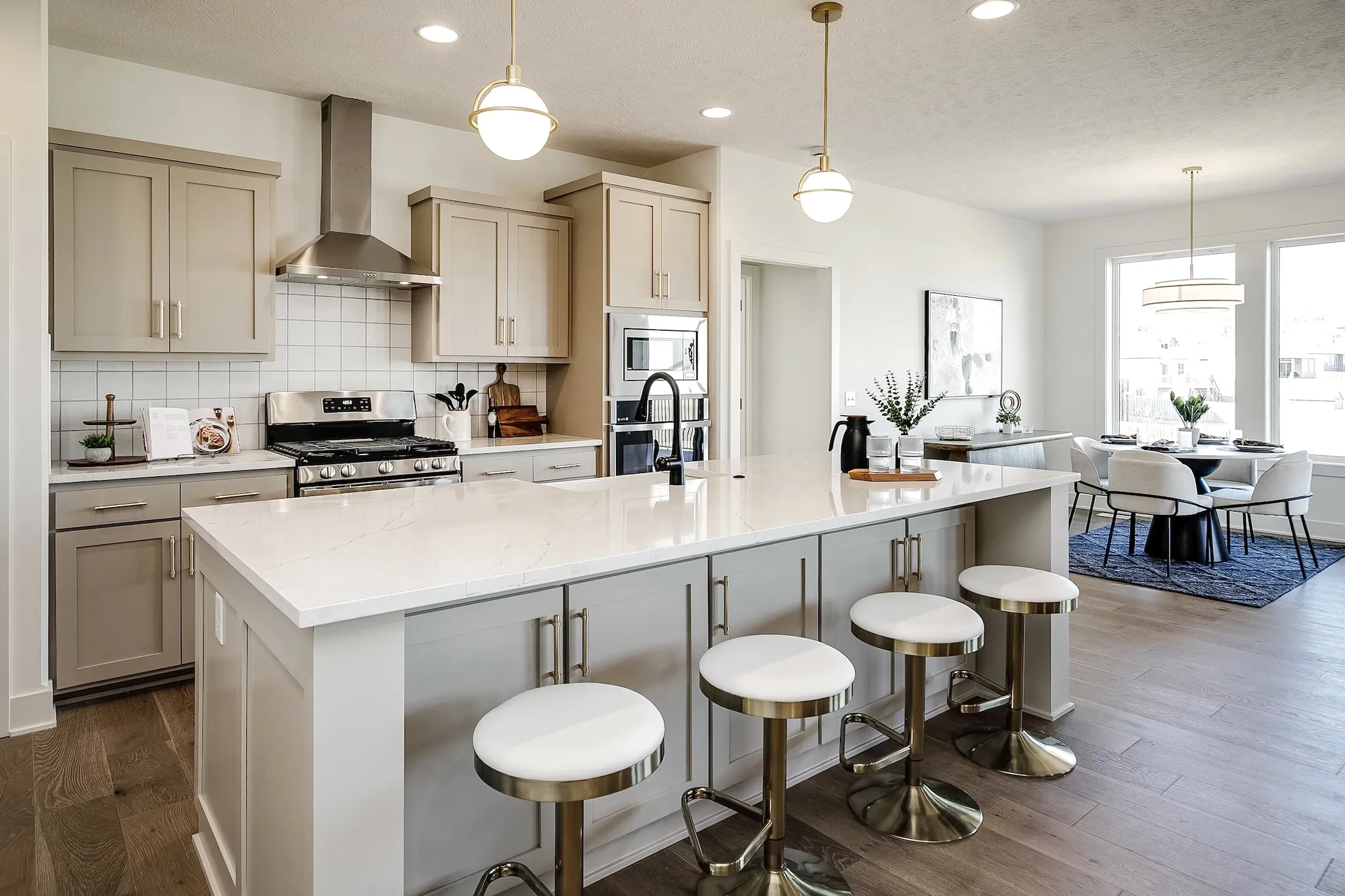 Kitchen island with pendant lights and bar stools