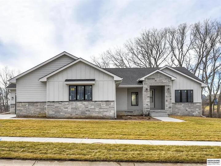 Home with stone front and covered entry
